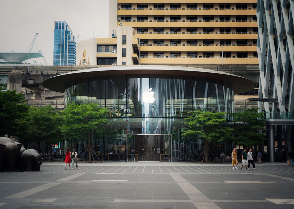 Contemporary glass structure in a bustling city, showcasing sleek architecture and urban life.